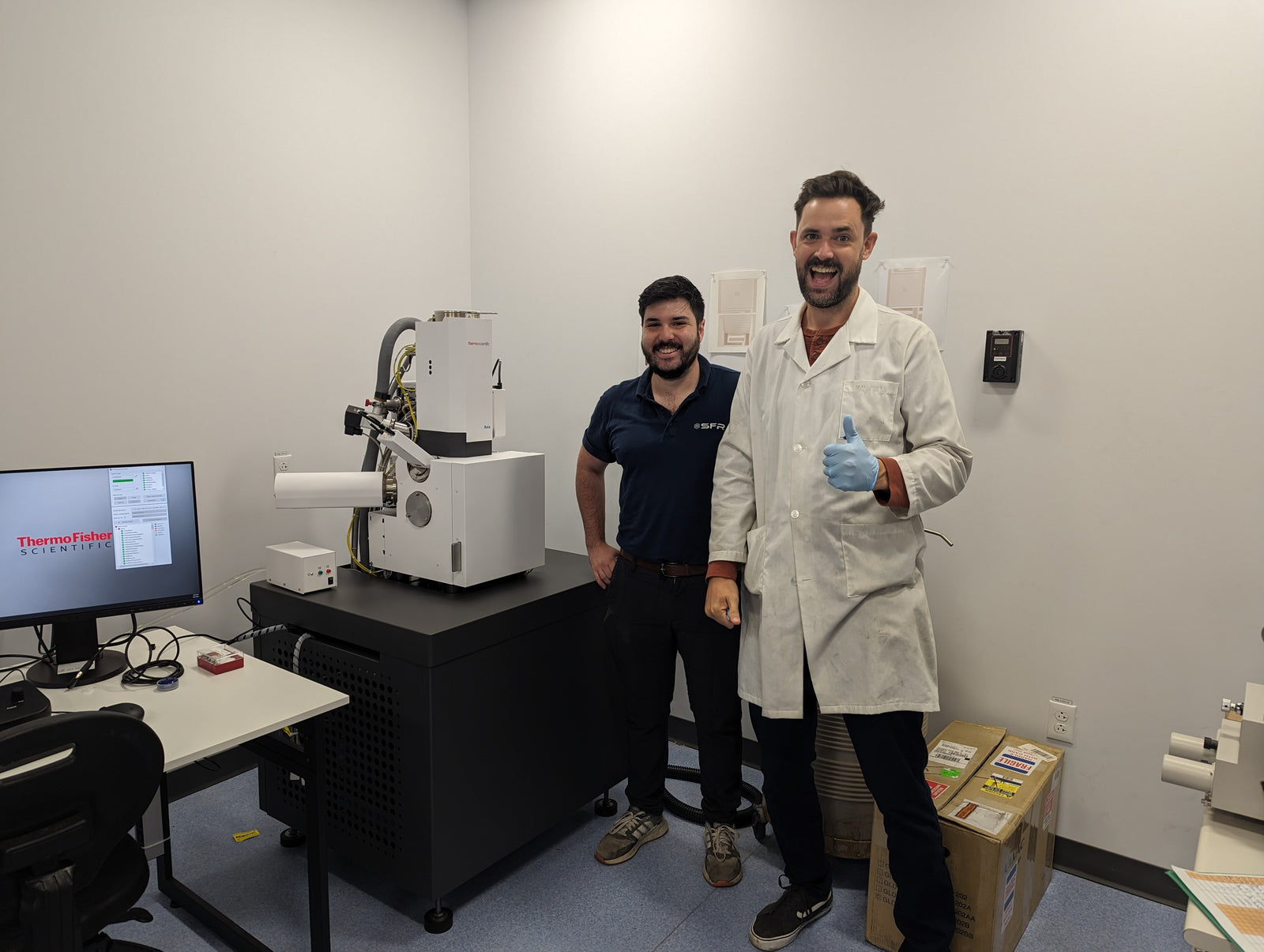 Seen in the image are Professor Kevin Plucknett and Luc Barraza with the newly installed Thermo Fisher Scienctific Axia ChemiSem system in a white room. 